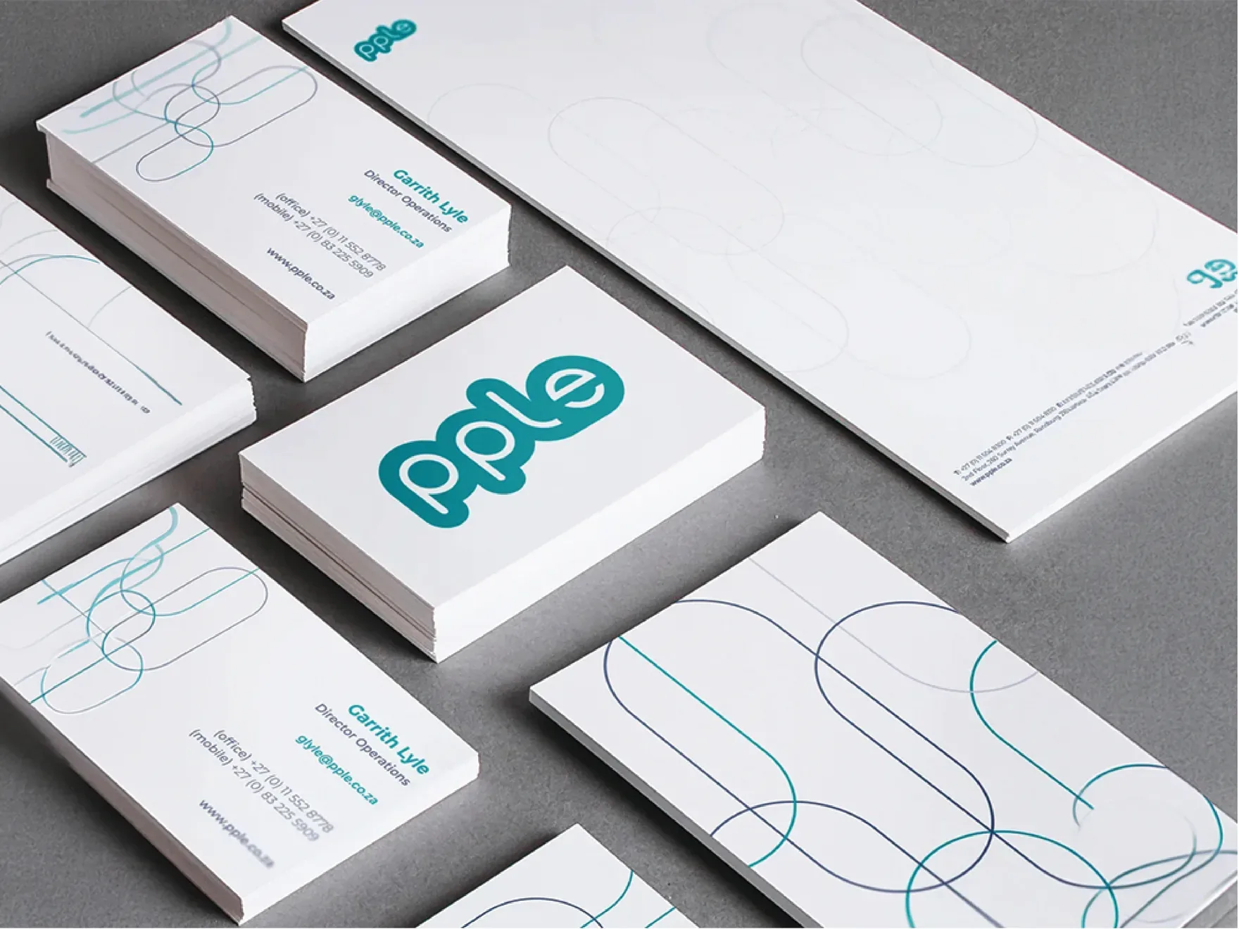 PPLE business cards and envelopes with a fine geometric line motif drawn from the letterforms.